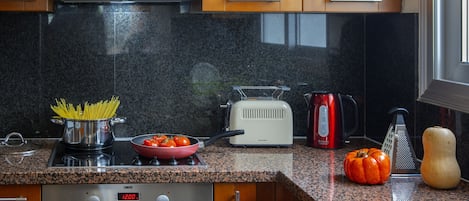 A kitchen with granite countertops, stainless steel appliances, and wooden cabinets.