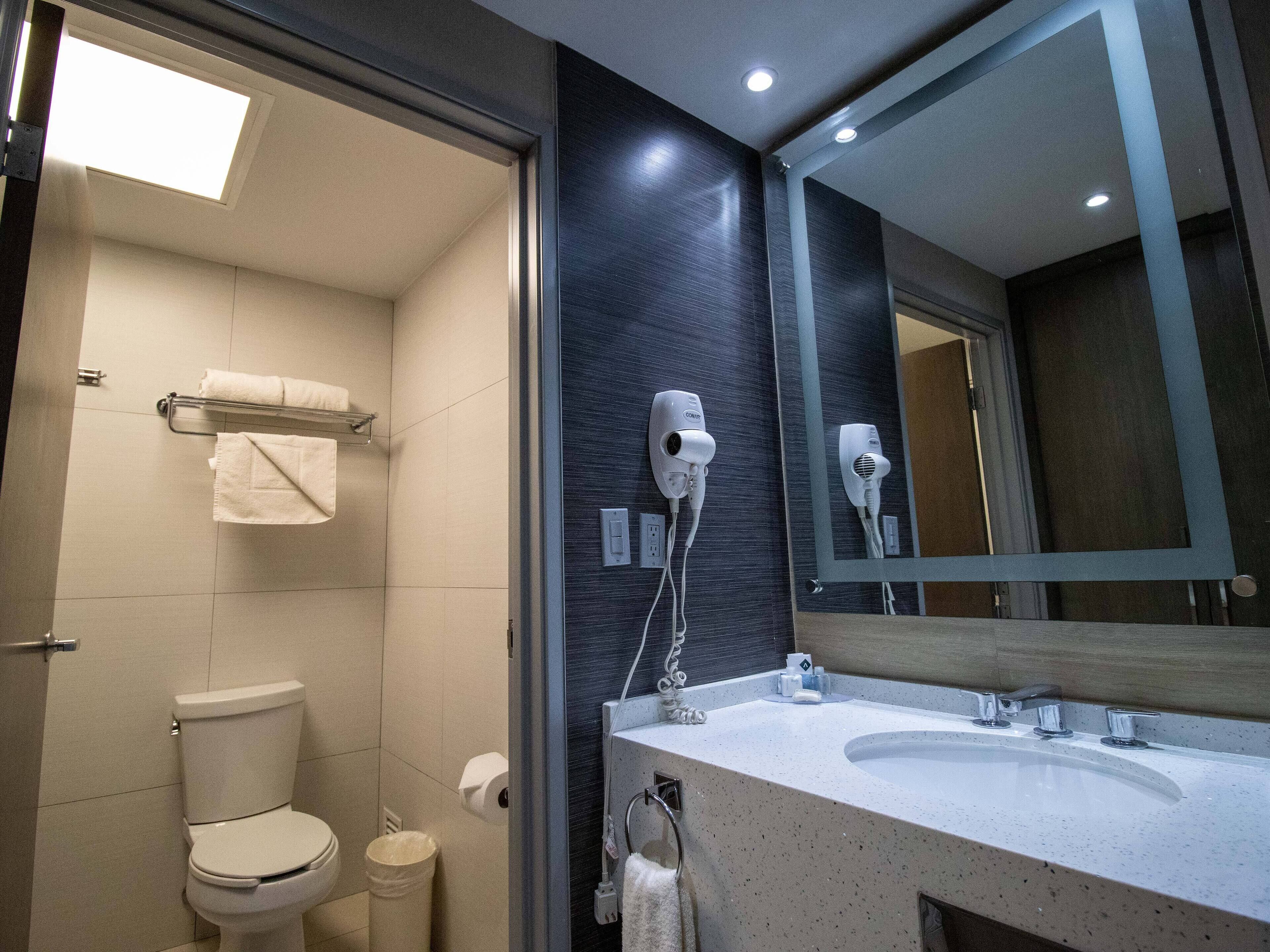 shower, designer toiletries, hair dryer, towels