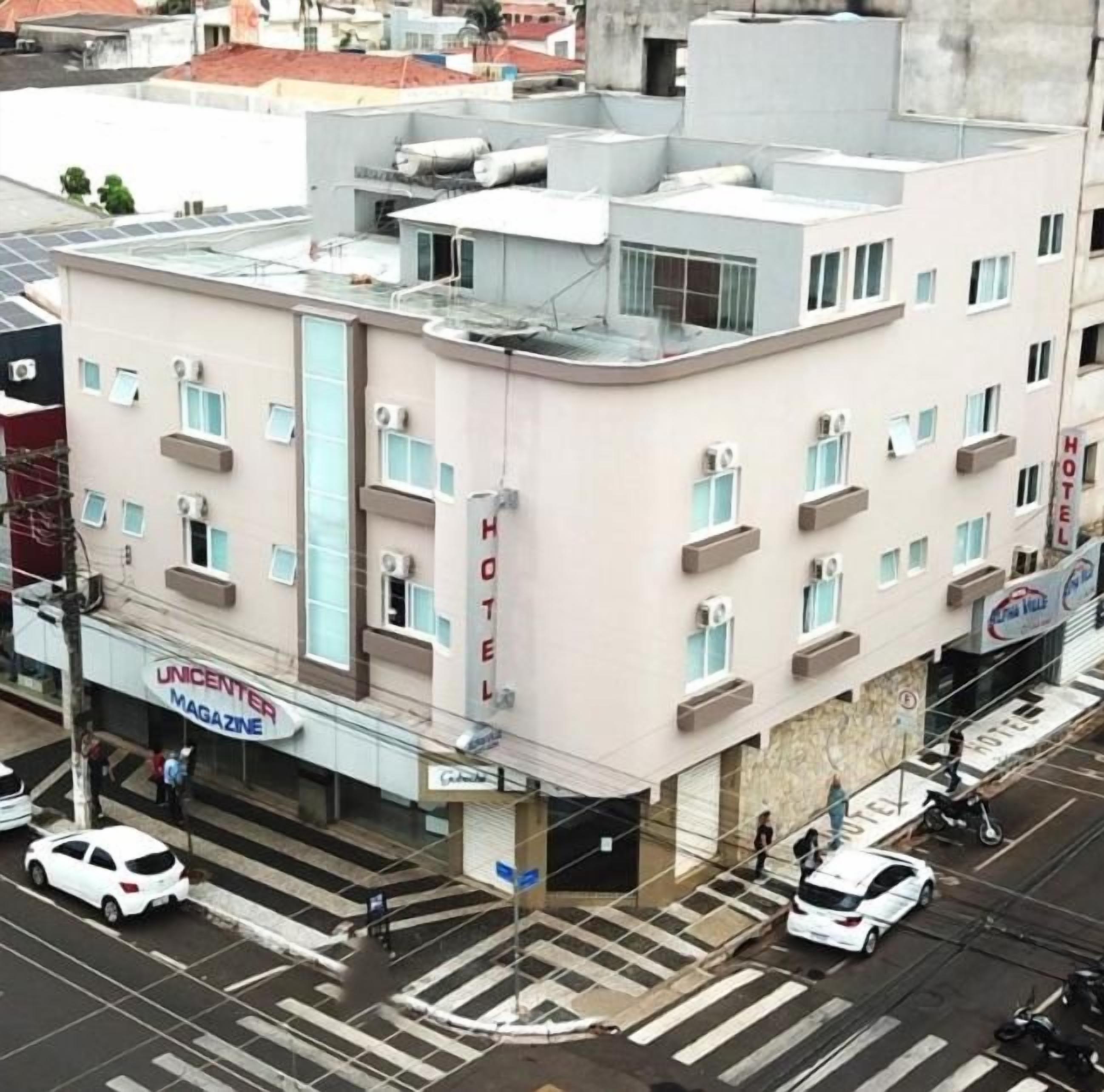 A hotel with a flat facade, multiple windows, and a visible entrance.