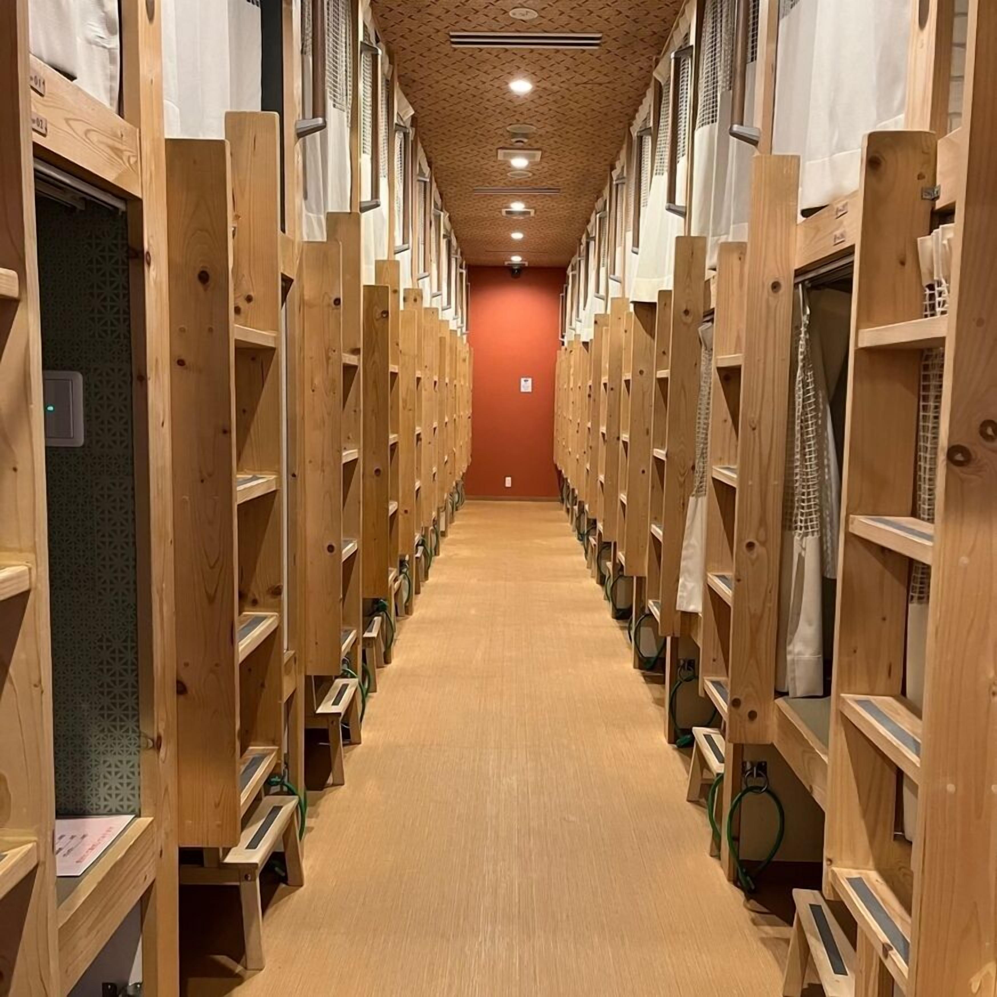 A row of wooden lockers with a patterned ceiling and a carpeted floor.