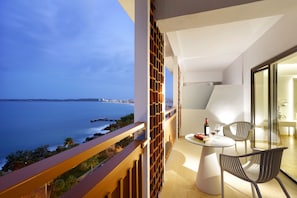 Enjoy a meal or social gathering on the balcony with a clear view of the sea and distant shoreline.