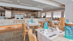 Enjoy a high-end dining experience in our stylish restaurant, featuring a sleek kitchen and comfortable seating areas.