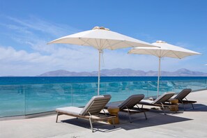 Am Strand, Liegestühle, Sonnenschirme, Volleyball
