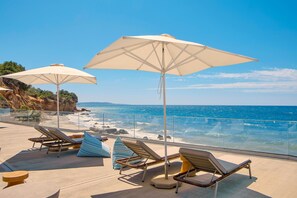 On the beach, sun loungers, beach umbrellas, beach volleyball