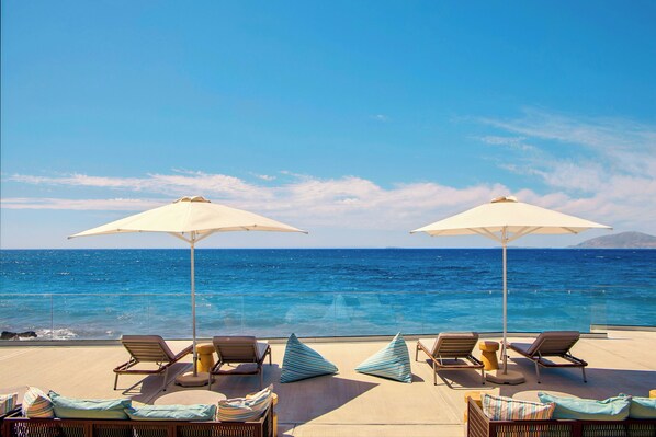 On the beach, sun loungers, beach umbrellas, beach volleyball