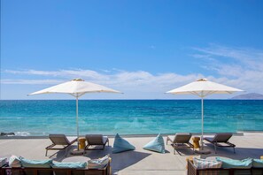 On the beach, sun-loungers, beach umbrellas, beach volleyball