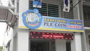 A laundromat with a sign reading "PLE COIN LAUNDRY" and a digital display stating "Clean & Hygienic". - Putra One Avenue Hotel (Seri Kembangan)