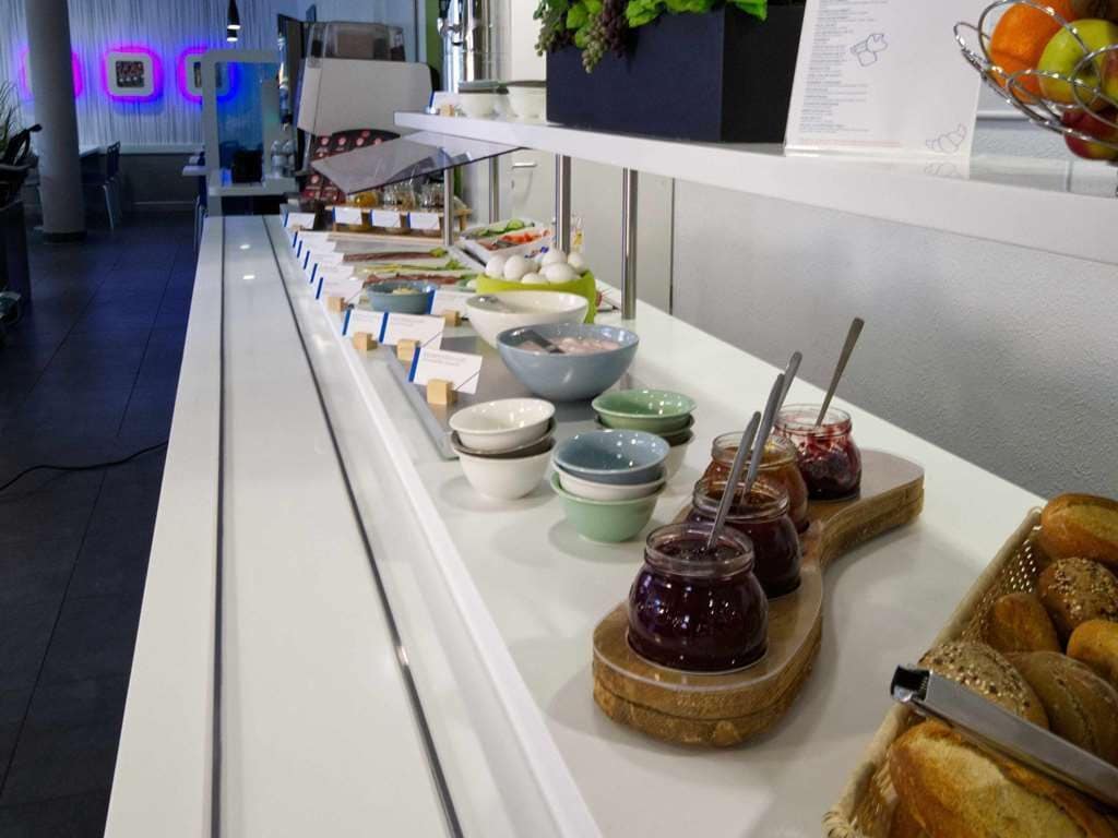 A buffet with various food items and condiments.