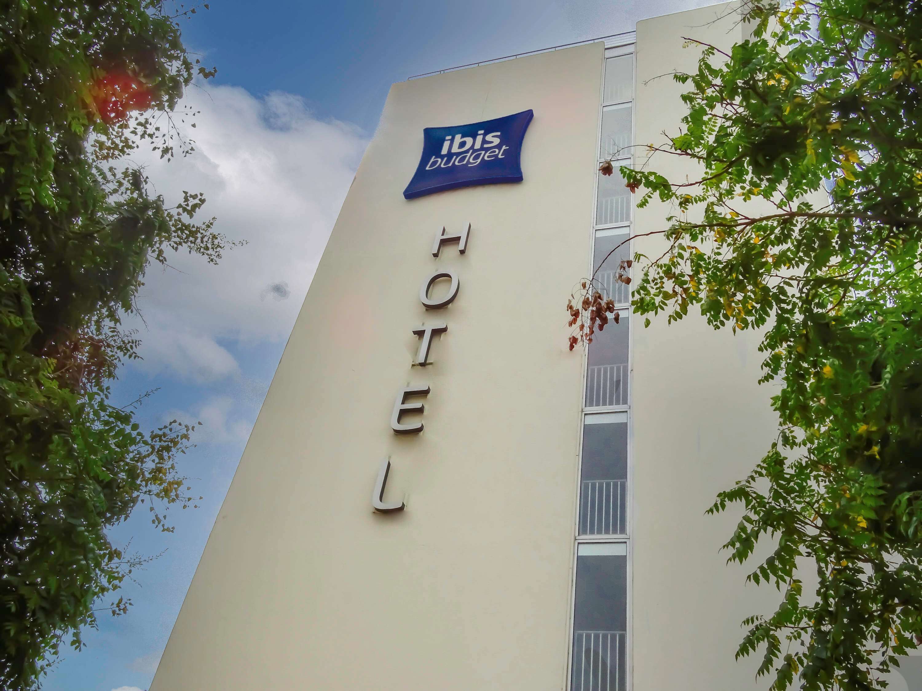 Un letrero de hotel con el nombre 'ibis budget' y la palabra 'HOTEL' en la fachada de un edificio.