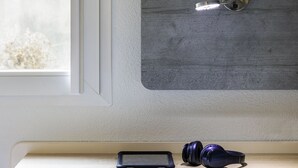 A room with a window, a mounted stethoscope, and a shelf with a smartphone and headphones. - ibis budget Bordeaux Centre Gare Saint Jean (Bordeaux)