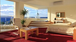 A bedroom with a large window, a bed, a desk, and a chair. - Sealight Resort Hotel (Kusadasi)