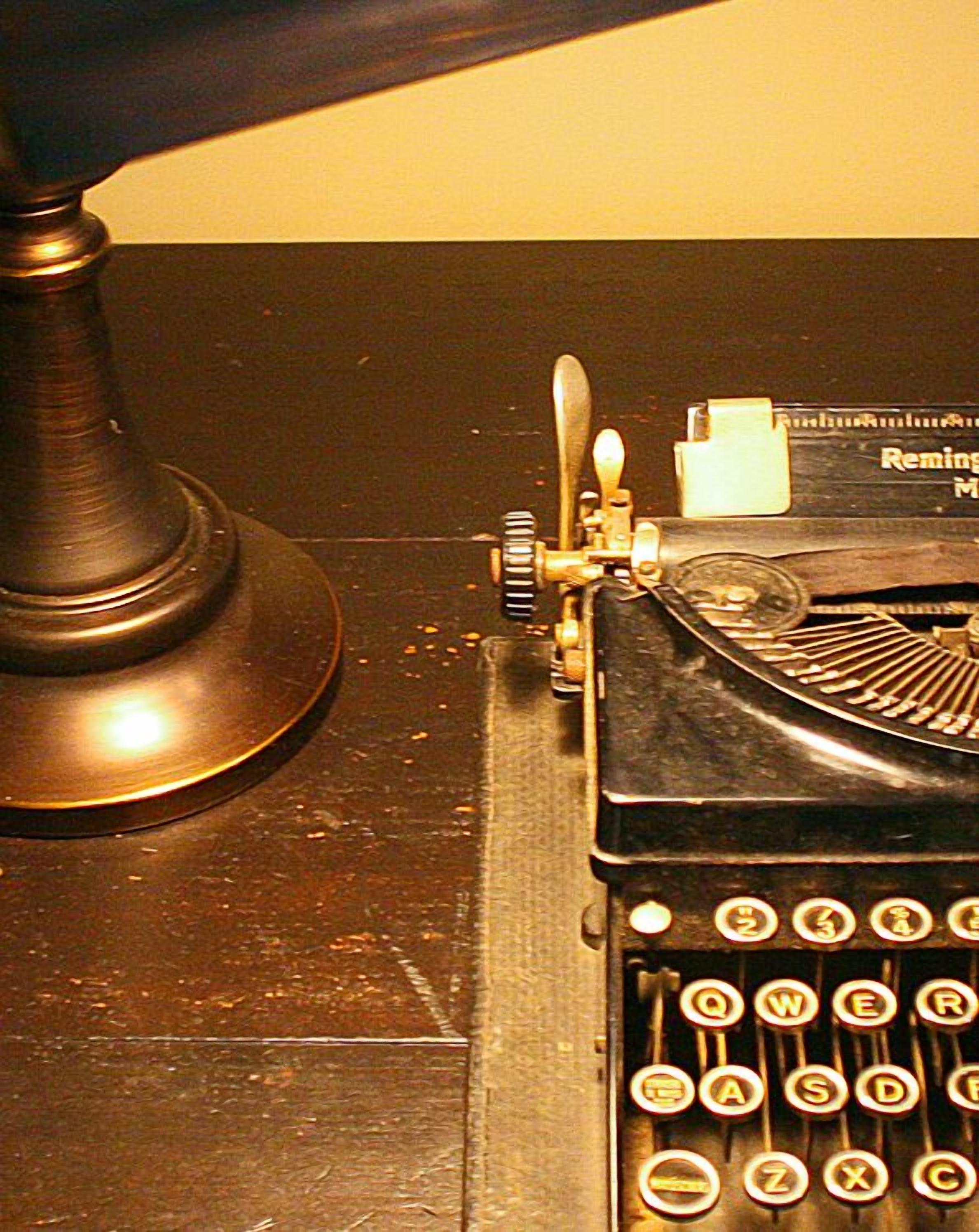 A vintage Remington typewriter with a metal base and a paper tray.