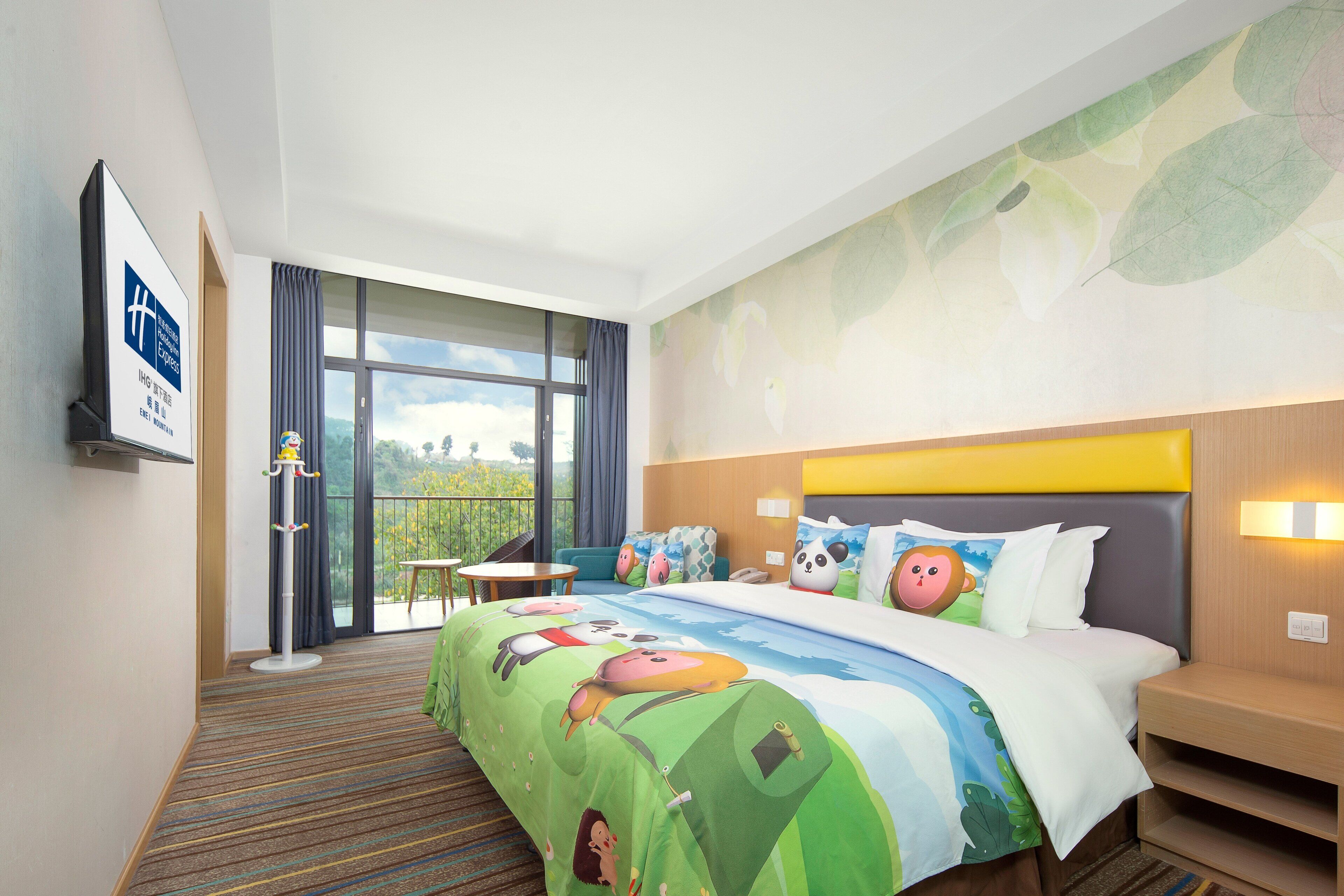 A hotel room with a large bed, a balcony with a view, and a coat rack.