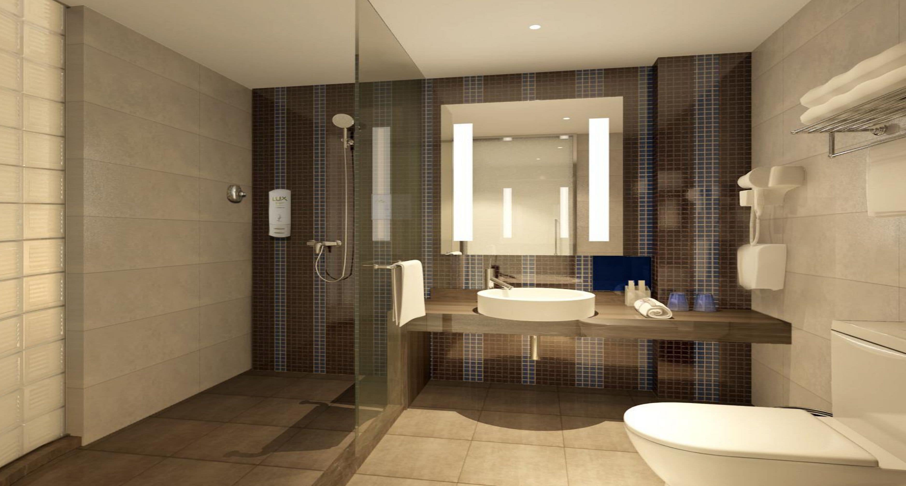 A modern bathroom with a glass-enclosed shower, a sink with a mirror, and a toilet.