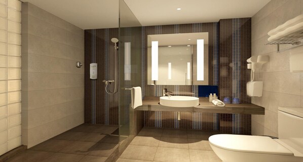 Une salle de bain moderne avec une douche à parois de verre, un lavabo avec un miroir et des toilettes.