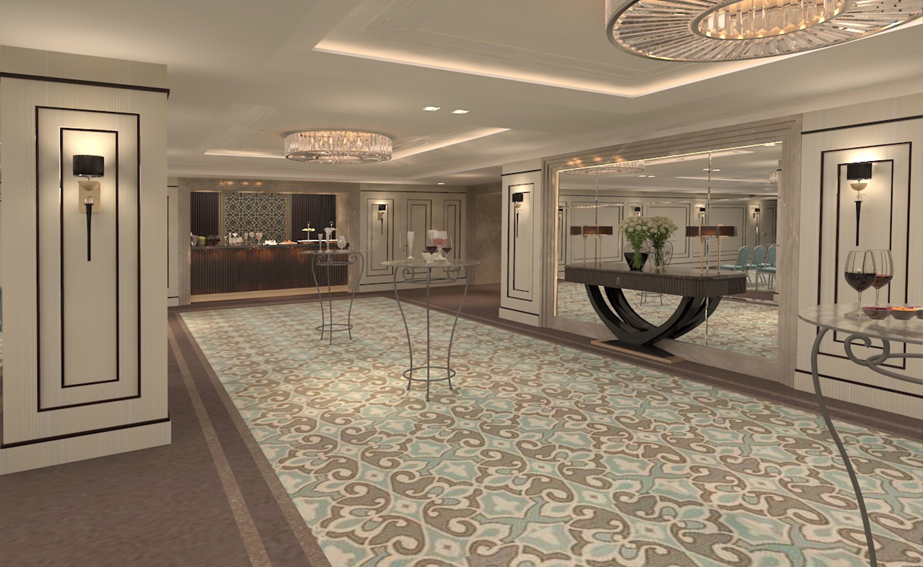 A spacious hotel lobby with a patterned carpet, a reception desk, and a dining area with a round table and chairs.