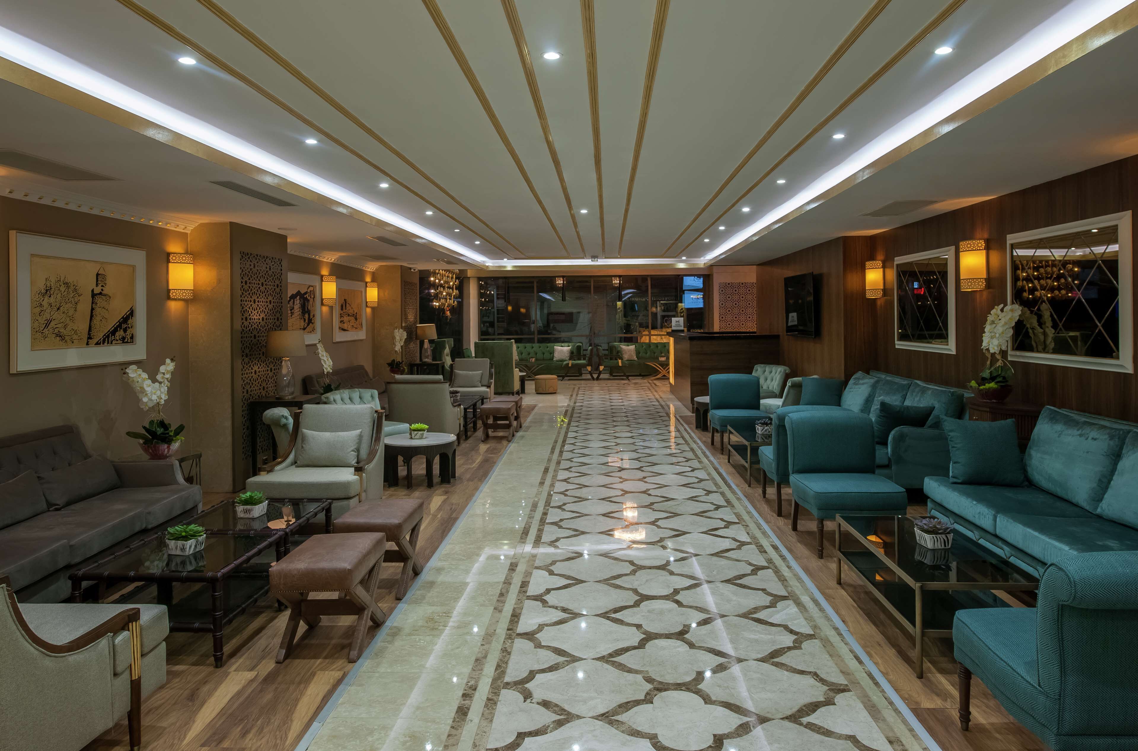A spacious, well-lit living area with a central rug, sofas, and a coffee table.