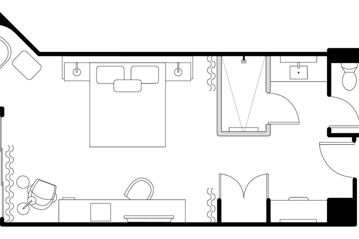 A floor plan of a hotel room with a bathroom, a kitchenette, a dining area, and a living room.