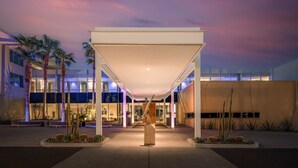 A modern building with a covered entrance, palm trees, and cacti. - Mountain Shadows Resort Scottsdale (Paradise Valley)