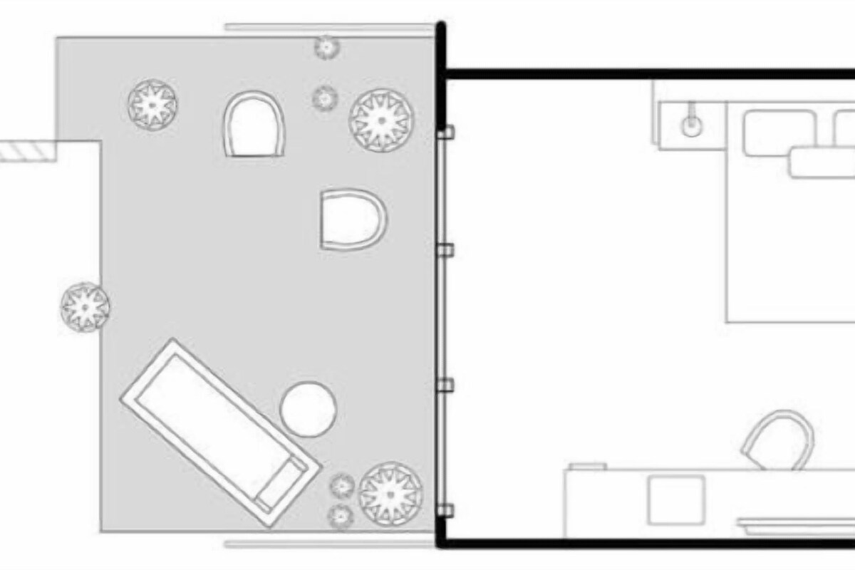 A hotel floor plan with a large open space, a kitchen area, and a bathroom.