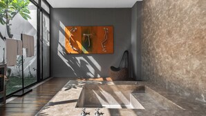 A modern bathroom with a large bathtub, a glass shower enclosure, and a large window allowing natural light. - Ease Motel (Caotun)