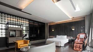 A modern hotel room with a large bed, a massage chair, a sofa, and a TV. - Ease Motel (Caotun)