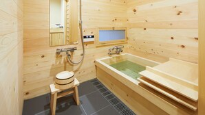 A wooden sauna room with a large bathtub, a small wooden stool, and a mirror on the wall. - Nakano-an (Kyoto)