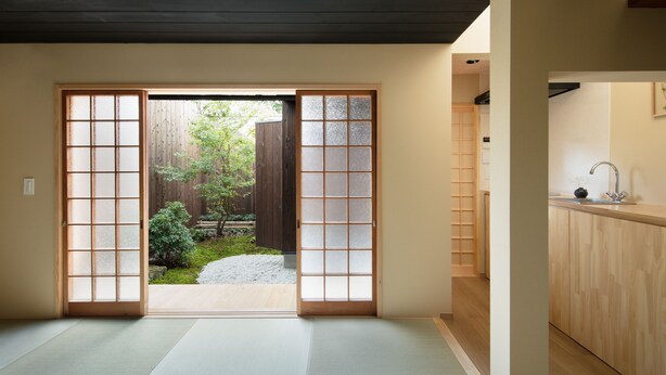 A traditional Japanese room with tatami flooring, a sliding door leading to a garden, and a wooden interior. - Nakano-an (Kyoto)
