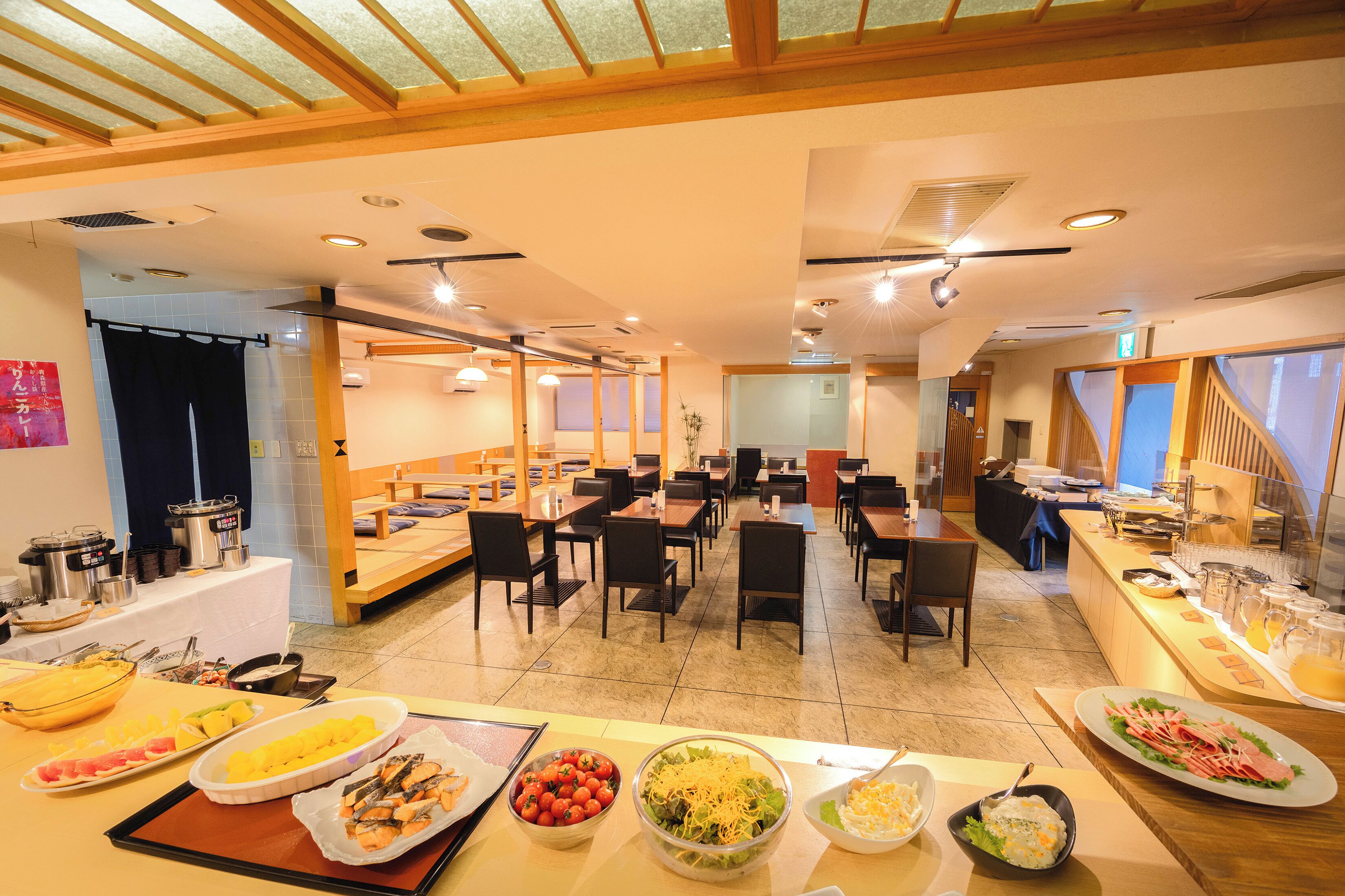 A buffet-style breakfast area with various food options and seating arrangements.