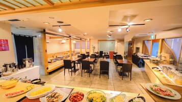 A buffet-style breakfast area with various food options and seating arrangements.