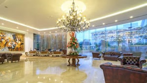 A spacious lobby with a polished floor, a grand chandelier, and comfortable seating areas. - Park Regis Goa (Arpora)