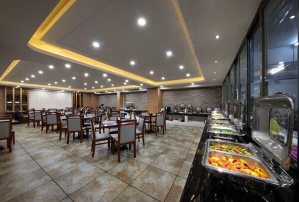 A buffet setup with multiple food stations and seating areas.