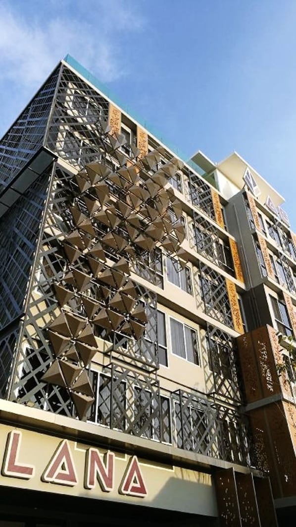 A building with a distinctive geometric facade and the name "LANA" visible on the lower part.