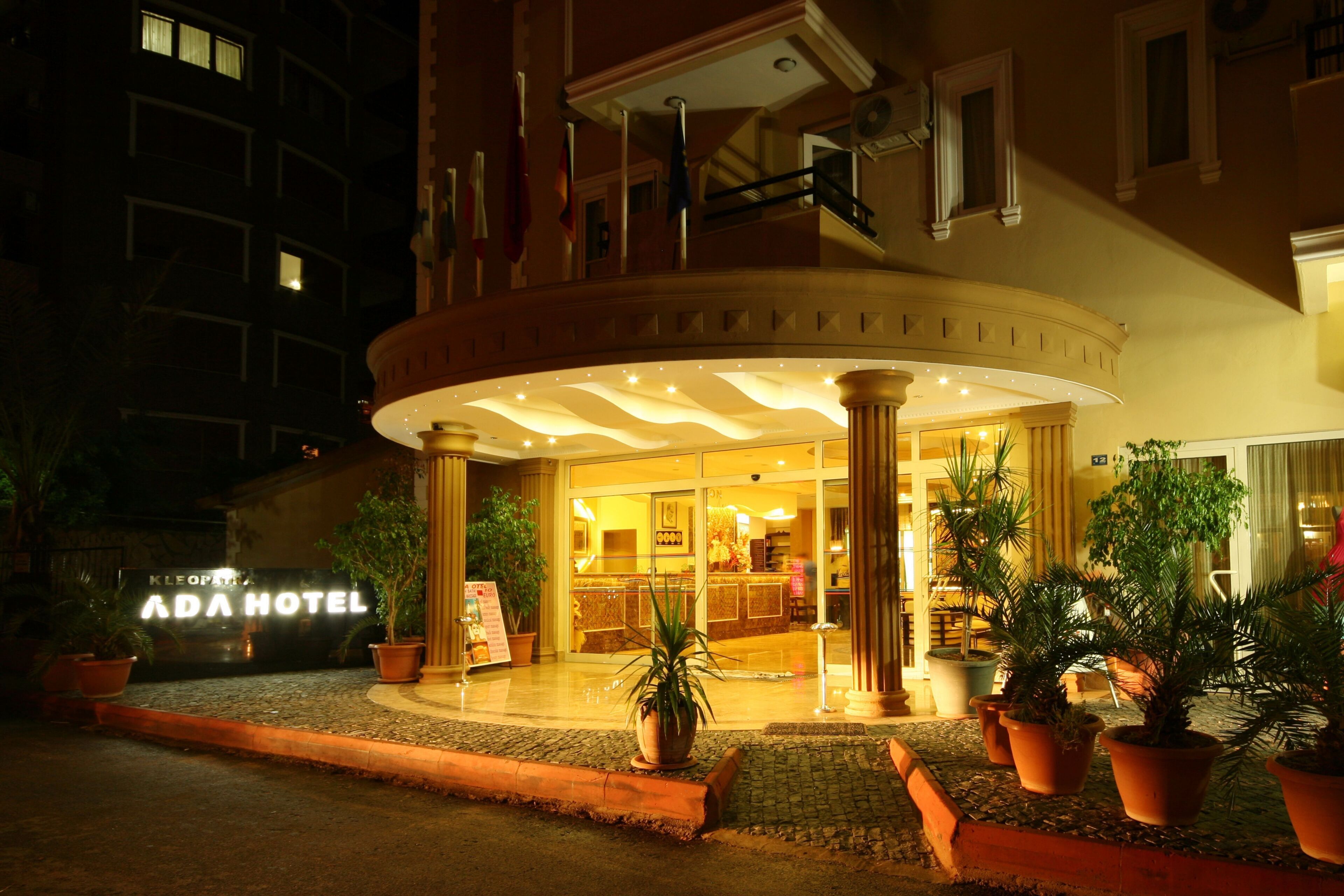 The ADA HOTEL entrance with a circular lobby, potted plants, and a visible reception area.
