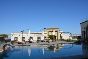 Seasonal outdoor pool, pool umbrellas, pool loungers