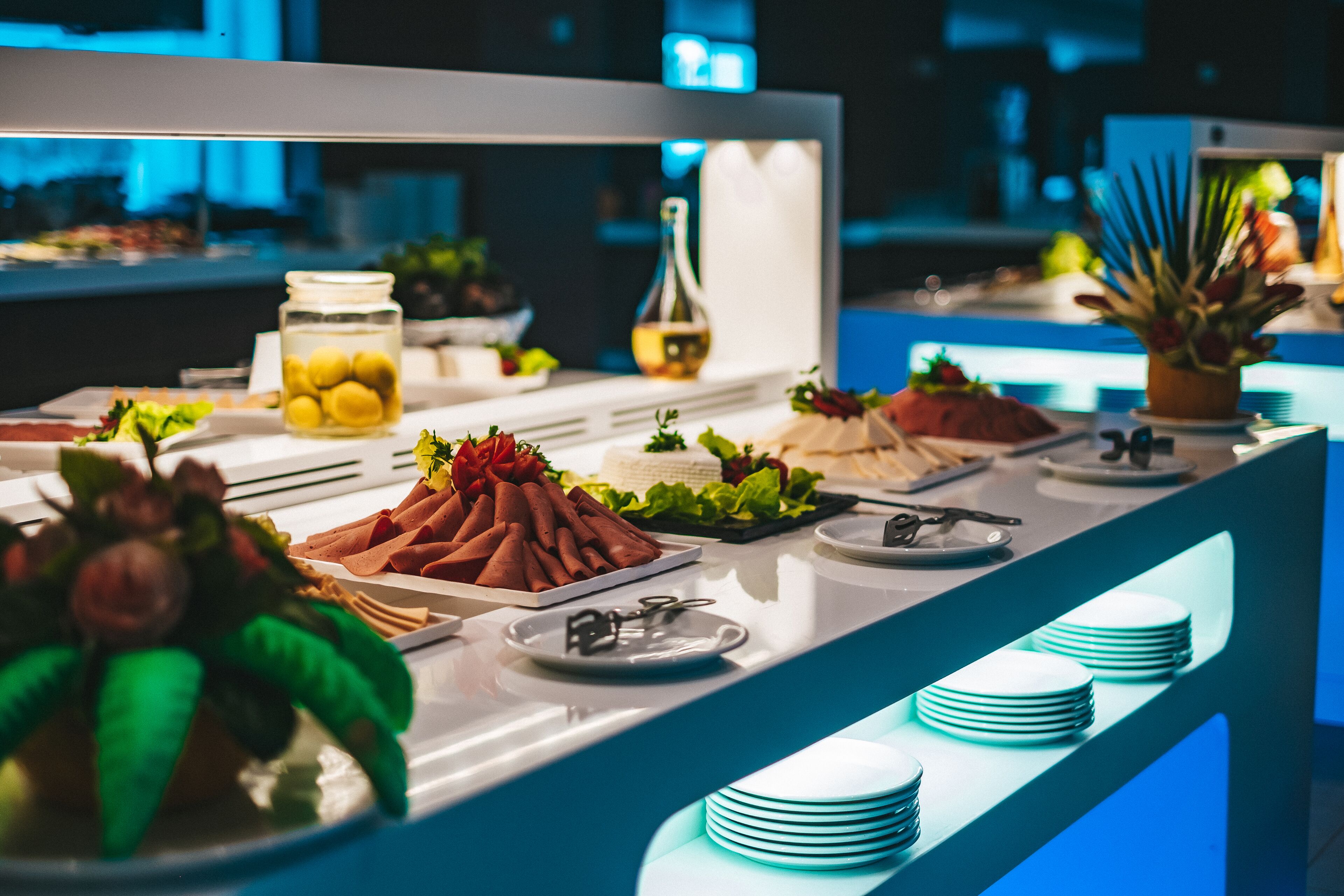A buffet with various food items and a decorative centerpiece.