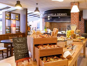 A bakery counter with various baked goods and a chalkboard sign.
