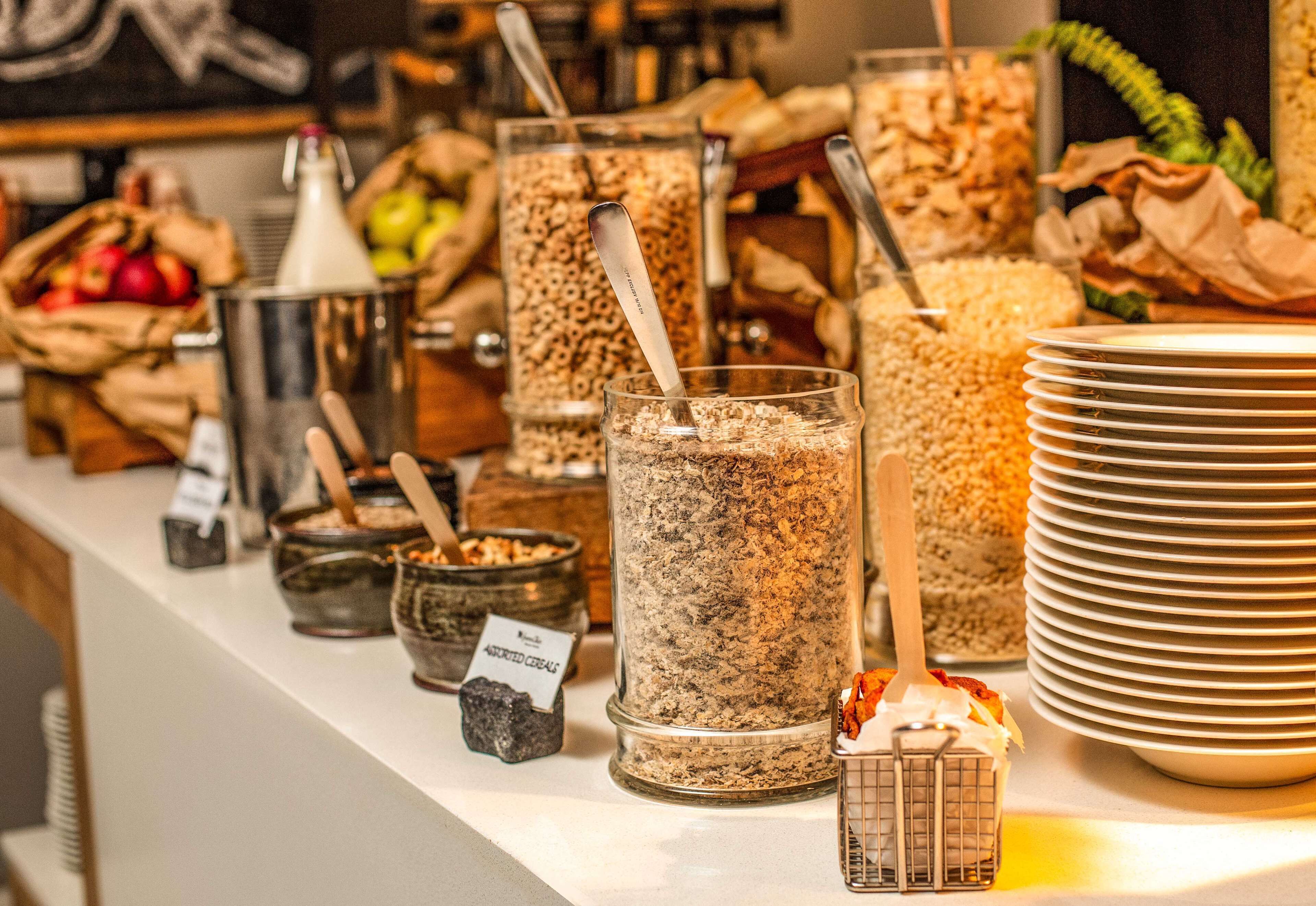 A buffet area with various food containers and utensils.