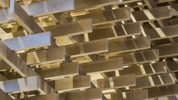A modern interior with a geometric wooden ceiling design.