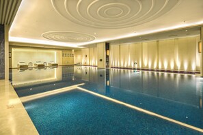 Indoor pool, open 7:00 AM to 11:00 PM, pool loungers, lifeguards on site