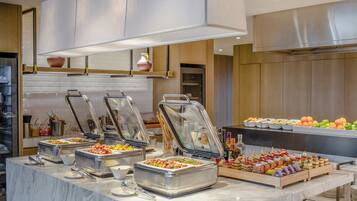 A buffet setup with multiple food stations and a variety of dishes.