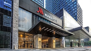 A modern Marriott hotel entrance with a prominent logo, large glass windows, and a covered entrance area. - Chengdu Marriott Hotel Financial Centre (Chengdu)