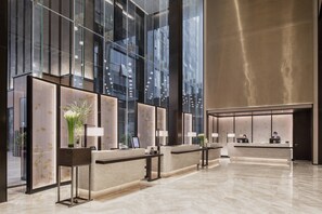 A modern hotel reception area with glass partitions, marble counters, and a spacious lobby. - Chengdu Marriott Hotel Financial Centre (Chengdu)
