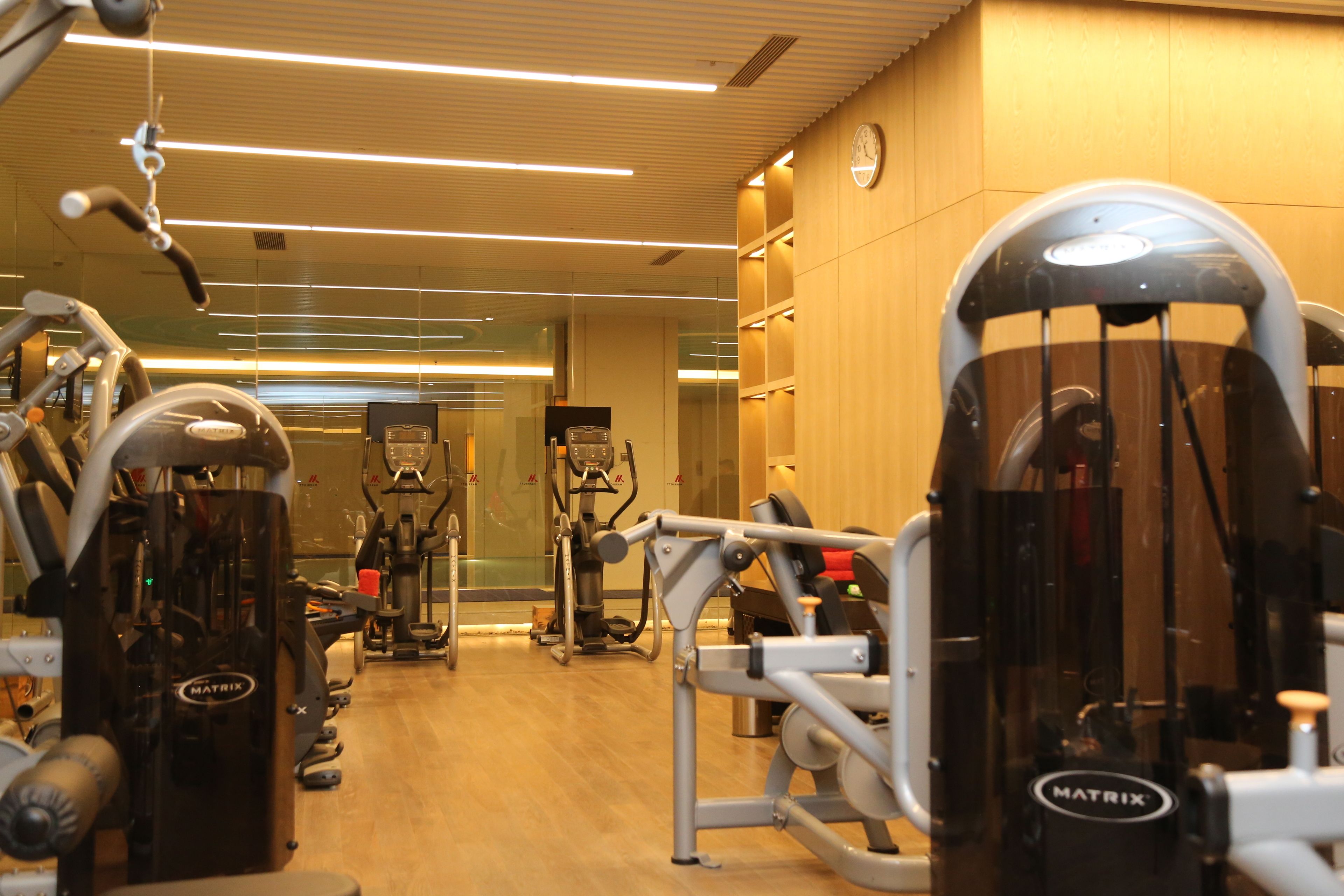 A gym with various exercise machines, including a large piece of equipment labeled MATRIX.