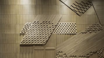 A modern interior with a geometric patterned wall and a polished marble floor.