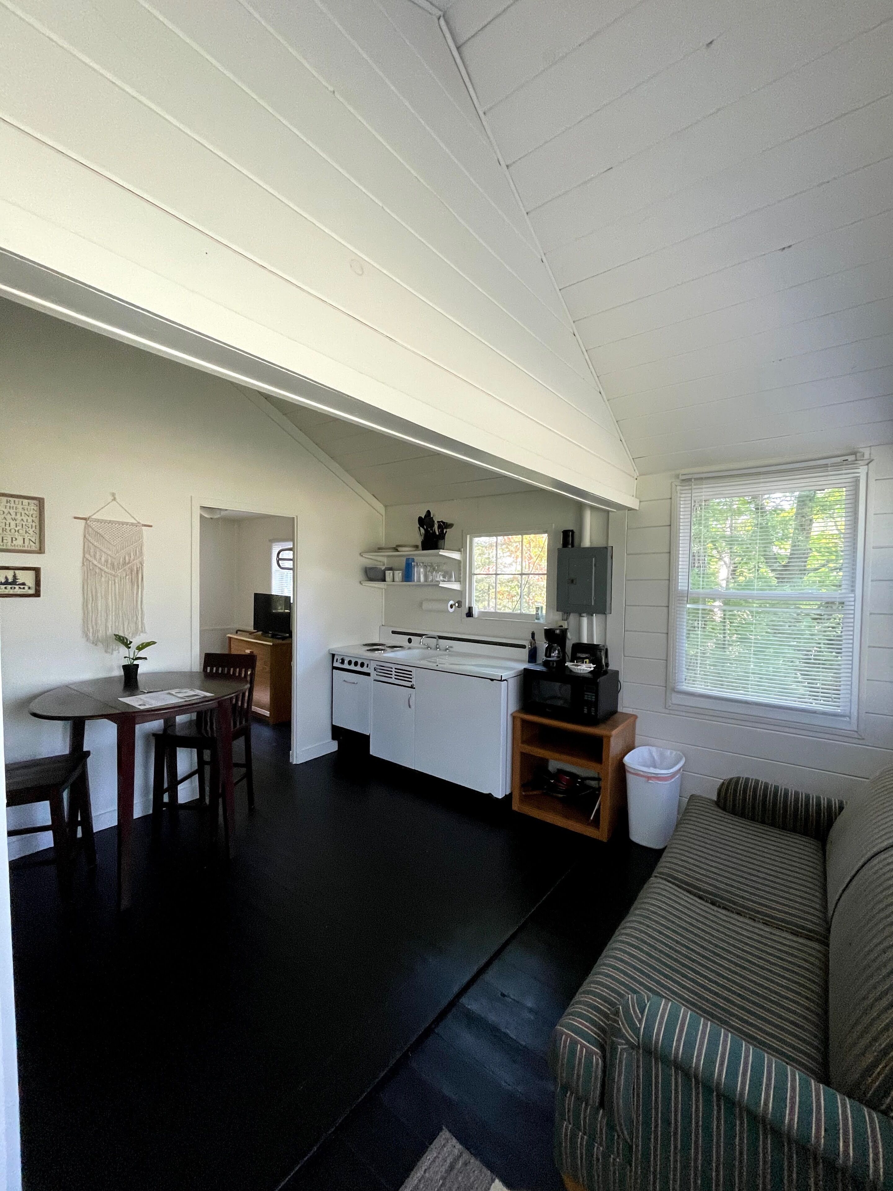 A compact living space with a kitchenette, a dining area, and a seating area.