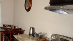 Basic Suite, 1 King Bed, Kitchen | Private kitchen | Coffee/tea maker, fridge, microwave