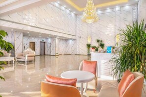 A hotel lobby with marble walls, a reception desk, and seating areas. - Lanting Hotel (MixC Baimajing Road Metro Station Branch ) (Kushan)