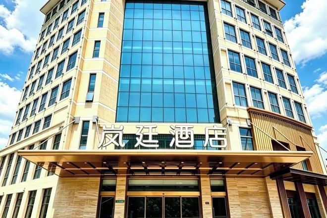 A hotel building with a modern facade, large windows, and a prominent entrance.
