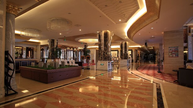 A spacious lobby with marble flooring, a reception desk, and a grand chandelier. - Country Garden Phoenix Hotel, XingAnMeng (Xing'an)